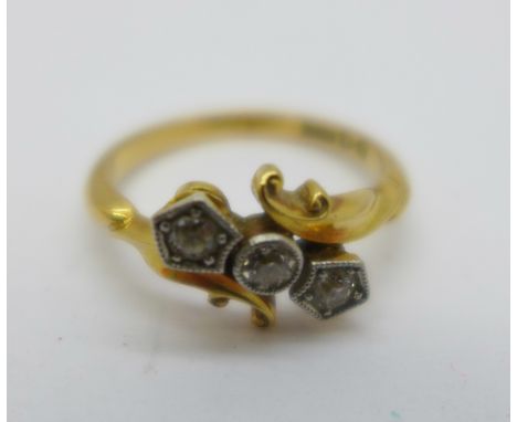 An 18ct gold and three stone diamond ring, 2.9g, K