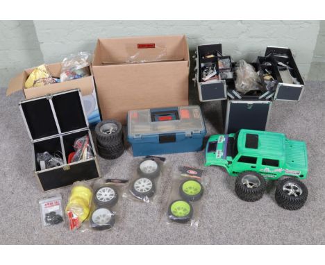 A good collection of remote control vehicles spares and repairs to include Hummer body shell, wheels of varying sizes, suspen