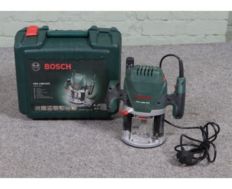 A Bosch POF 1400 Ace router, in hard case.  Some attachments missing, one clasp missing from case.
