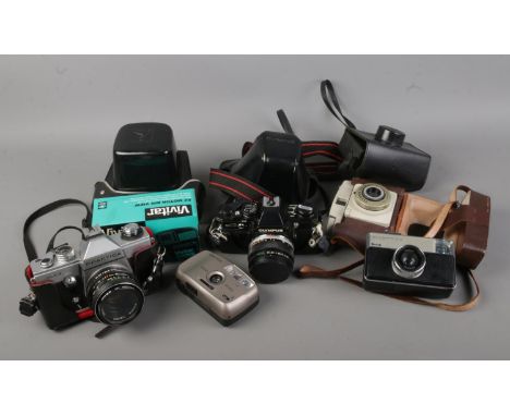 A collection of vintage cameras including Ilford Sporti 4, Kodak Instamatic 233, Olympus OM10, Praktica PLC3 etc