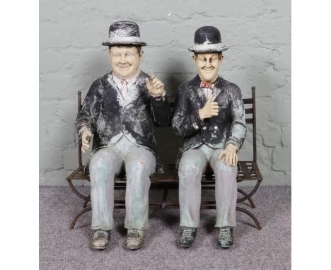 A large resin figure of "Laurel and Hardy" seated on a metal bench, which can be separated into three pieces.  Measures heigh