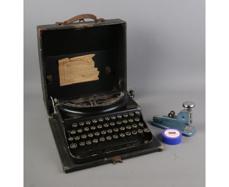 A Remmington Home Portable typewriter with Vanguard Type No4 stapler and ink.