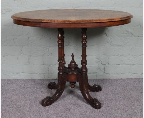 A Victorian inlaid walnut oval side table, with decorative central bobbin pillar, raised on carved cabriole legs. Height: 67c