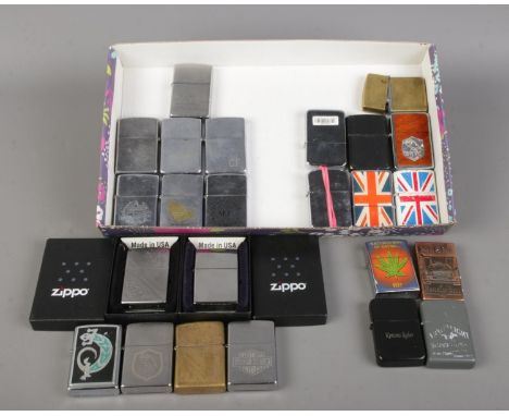 A collection of vintage pocket lighters, including thirteen examples from Zippo and other brands such as Star.