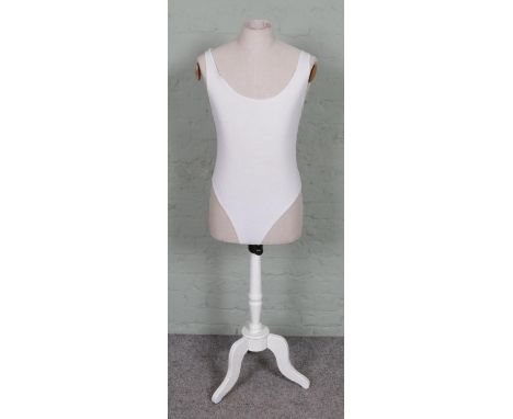 Vintage dressmaker's mannequin with a wooden tripod stand, standing 142 cm tall.