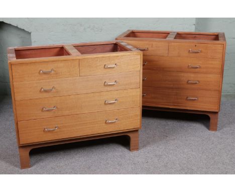 A pair of mid 20th century teak MOD military chest of drawers. With a configuration of two over three drawers. All raised on 
