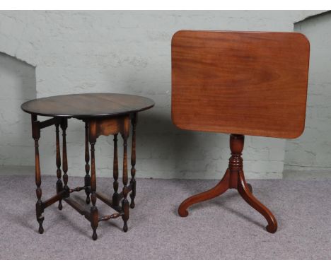 A small tilt top table on tripod base together with a mahogany drop leaf gate leg table with bobbin turned supports.
