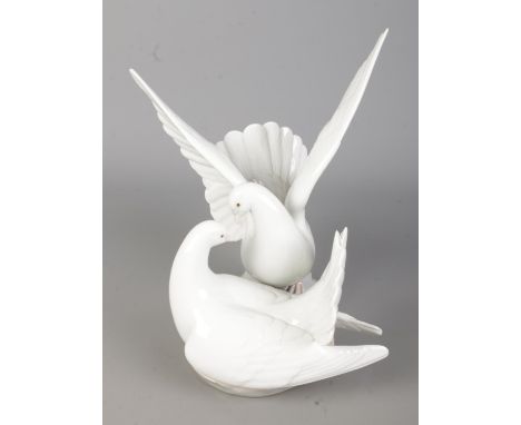 A boxed Lladro ceramic figure group titled 'Love Nest' (C573C/6291) depicting a pair of white doves. Approx. height 24.5cm.
