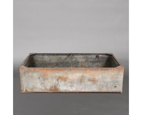 A RIVETED GALVANISED WATER TROUGH. late 19th or early 20th century, height 46cm, depth 106cm, width 177cm Location: - Hertfor