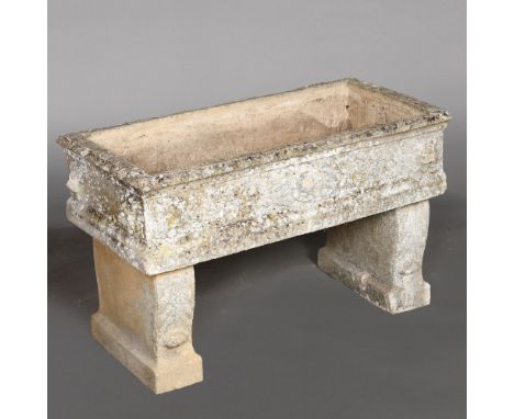A STONE TROUGH PLANTER ON TWIN SUPPORTS. with lion mask decoration, height 56cm, width 94cm, depth 44cm Location: - Berkshire
