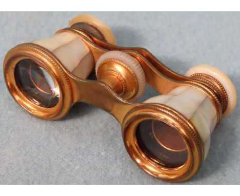 Pair of vintage french gilt metal and mother of pearl decorated adjustible opera glasses

Appear in reasonable used condition