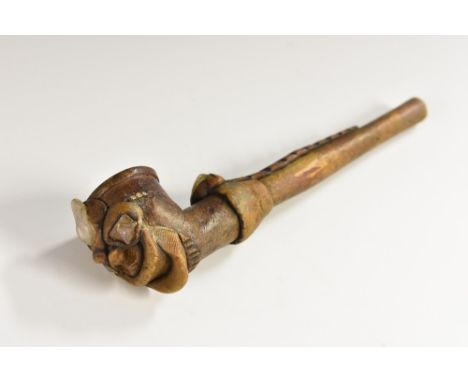 Tribal Art - a Maori hardwood contemplative evening pipe, the bowl as a grotesque man, inset and applied with irregularly opa