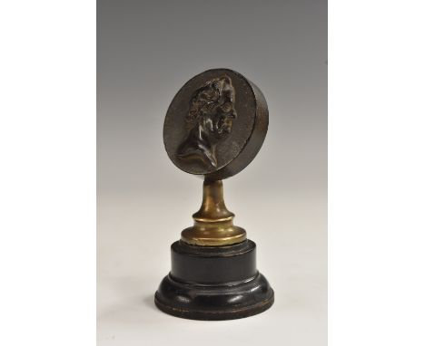 A 19th century bois durci circular portrait medallion, 4cm diam, mounted for display