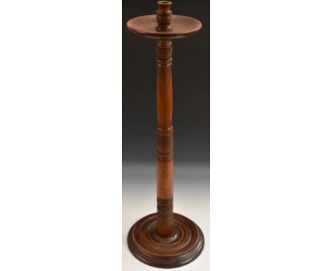 A 19th century mahogany floor standing candlestick, dished wax pan, ring-turned sconce and column, draught-turned base, 89cm 