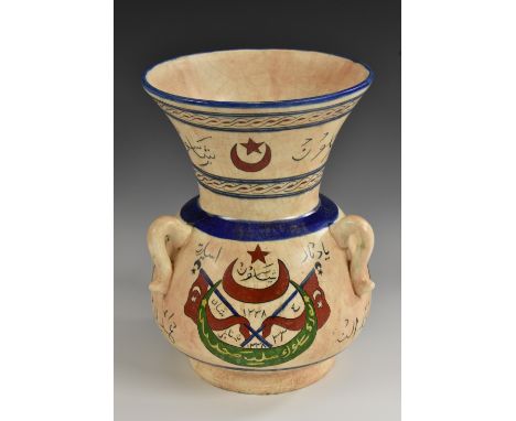 An Ottoman Turkish Islamic mosque lamp, brightly painted with star-and-crescent, flags and Arabic script, on a crackle glazed