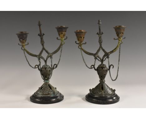 A pair of 19th century French two-light candelabra, the pierced pillars and socles in relief with strapwork, belge noir bases