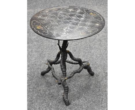 A 19th century painted slate circular table top, marked out for chess, the associated tripod base formed of kudu horns, 61cm 