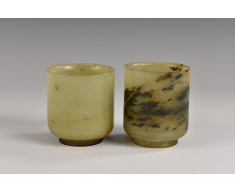 A near pair of Chinese pale green jade cylindrical libation cups, of small proportions, with alternating russet and dendritic