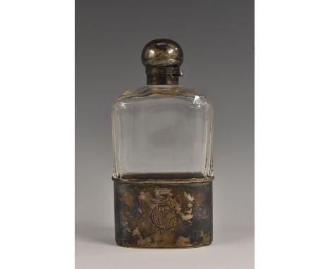 A late Victorian silver-mounted and cut glass gentleman's hip flask, domed screw-action cover, the cup base with silver gilt 