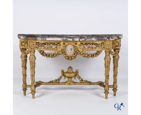 A richly carved and gilded console table in LVXI style with a grisaille painting on marble. Late 19th century. | 149 x 86 x 4