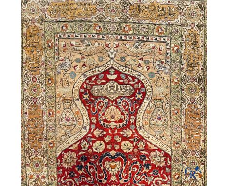 Oriental carpets: Hereke, a finely knotted silk carpet with inscriptions and birds in a floral decor. | 158 x 98 cm.