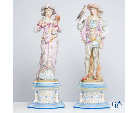 Exceptional pair of large statues in coloured and gilded biscuit porcelain depicting a falconer and a noblewoman in Renaissan