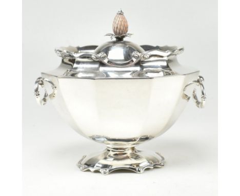 An early 20th century hallmarked silver tea caddy. The caddy in the form of a tureen having a footed base rising to oval form