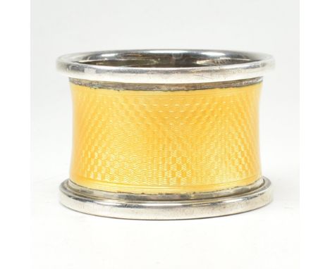 A George V hallmarked silver and yellow guilloche enamel napkin ring. Hallmarked for Birmingham, 1926. Makers mark MW. Weight