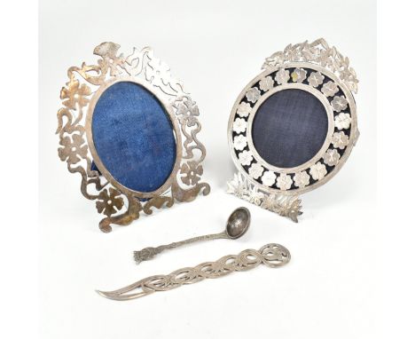 Two Egyptian silver picture frames paper knife and other spoon. The picture or photo frames each having pierced floral design