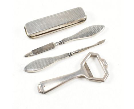 A George V hallmarked silver bottle opener and silver handled manicure set.&nbsp;The manicure set comprising of nail file, bu