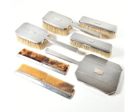 A George VI Mappin &amp; Webb hallmarked silver mounted vanity set. The set comprising of two hair brushes, two clothes brush