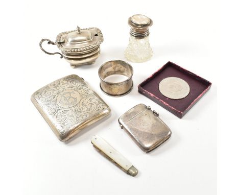 A collection of hallmarked silver items. The lot to include a George V cigarette case with etched scrolled design and central