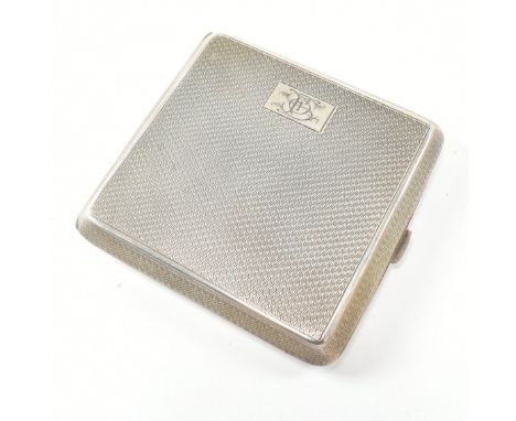 A George V hallmarked silver cigarette case. The Art Deco case having an engine turned design and monogrammed cartouche. Hall