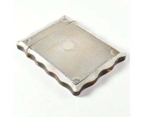 A white metal mounted tortoise shell and mother of pearl card case. The case having an inlaid mother of pearl border, tortois