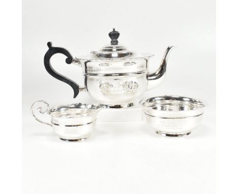 An early 20th century hallmarked silver tea service. The Edward VII three piece service comprising of a tea pot, sugar bowl a