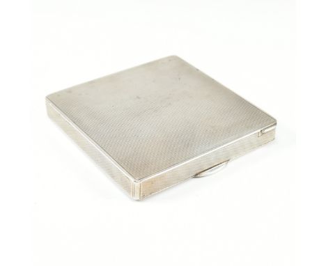 A continental 925 silver powder make up compact. The compact of square form having an engine turned design. The case opening 