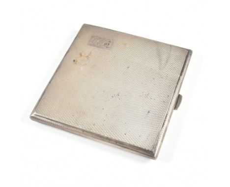 A George V hallmarked silver cigarette case. The case having an engine turned repeated pattern with monogrammed cartouche. Th