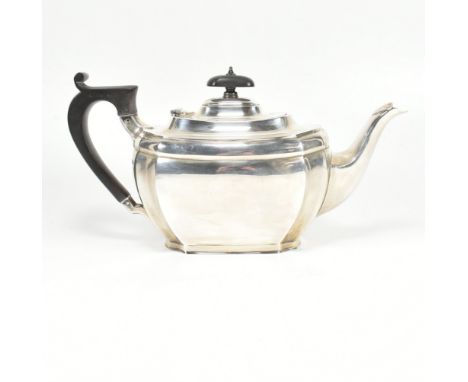 A 1920s hallmarked silver tea pot. The Art Deco tea pot having an ebonised wood handle and finial. Hallmarked for Sheffield, 