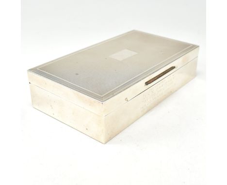 A 1970s hallmarked silver cigar box. The wood lined silver box having an engine turned repeated pattern with central vacant c