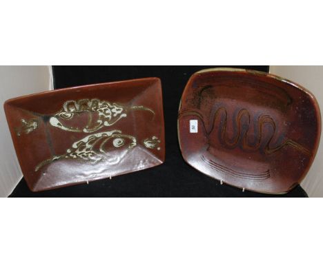 A Winchcombe Pottery rounded rectangular dish, slip decorated with Ox bow river design, together with another slipware dish d