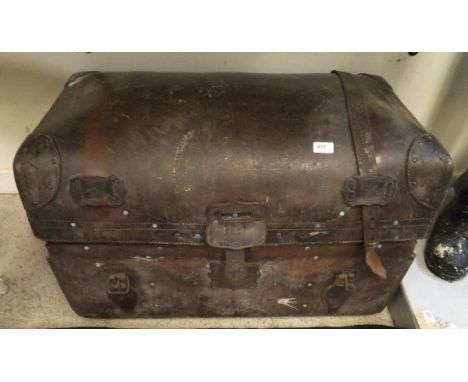 A brown leather trunk, wicker basket and bound leather carry basket
