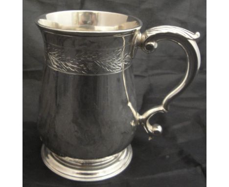 A mid 18th Century George II silver mug of baluster form with C scroll handle, engraved thistle and acanthus leaf decoration,