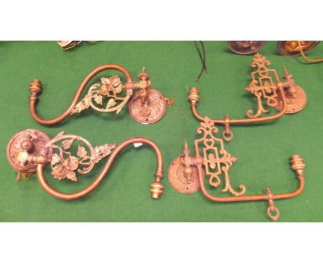 Two pairs of brass single branch wall light fittings, one with a flower on a branch decoration