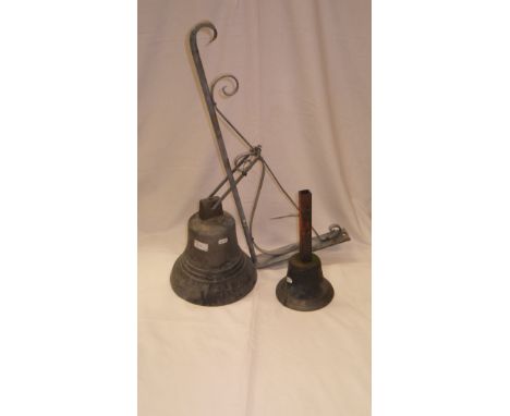 A Brass bell with later bracket, together with a hand bell