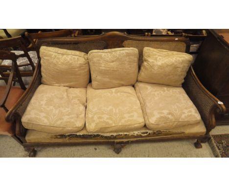 A mahogany three seat sofa with Bergere back and sides and three front cabriole legs to claw and ball feet