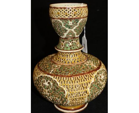 A Zsolnay gourd shaped reticulated vase glazed in gold and greens, raised on a circular foot, bearing impressed mark to base 