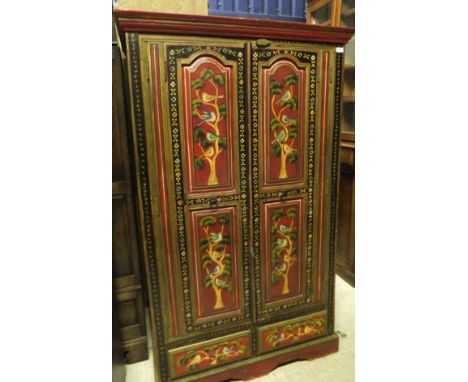 An Eastern painted two door wardrobe with two drawers to the base to bracket feet with shaped apron, the whole painted with b