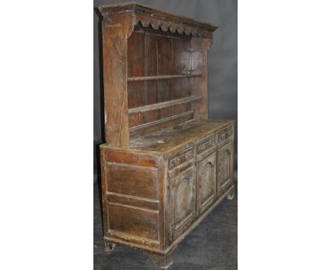 A 19th Century oak dresser, the canopy top over two shelves upon a base of three drawers and three cupboard doors, the centra