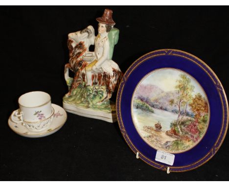 A Spode Copelands china plate decorated with figures in a row boat, signed "M Hazlitt", a Staffordshire pottery flat back fig
