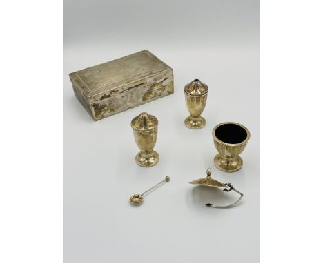 A silver cigarette box with engine turned decoration (as found); together with a silver three piece cruet set with plastic in